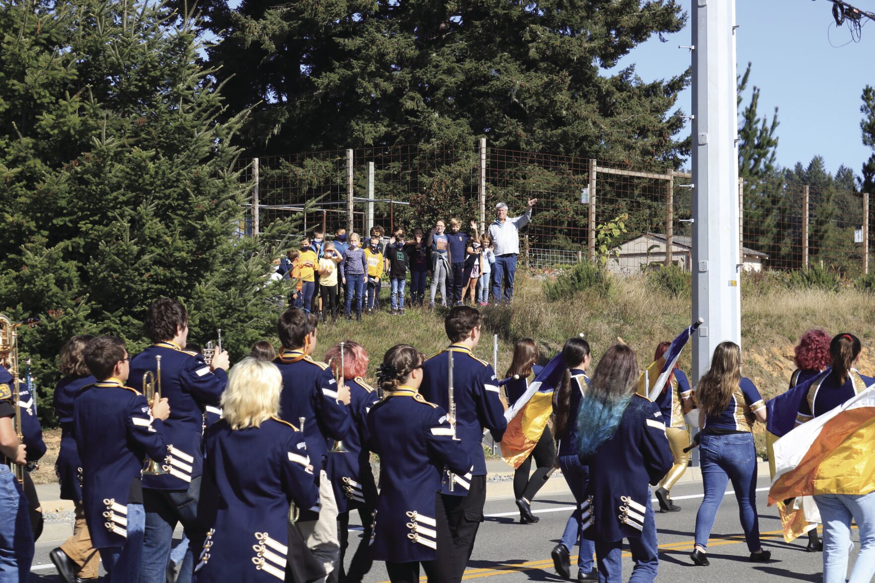 Third grade students from Kalmiopsis Elementary wave as marching band passes.jpg
